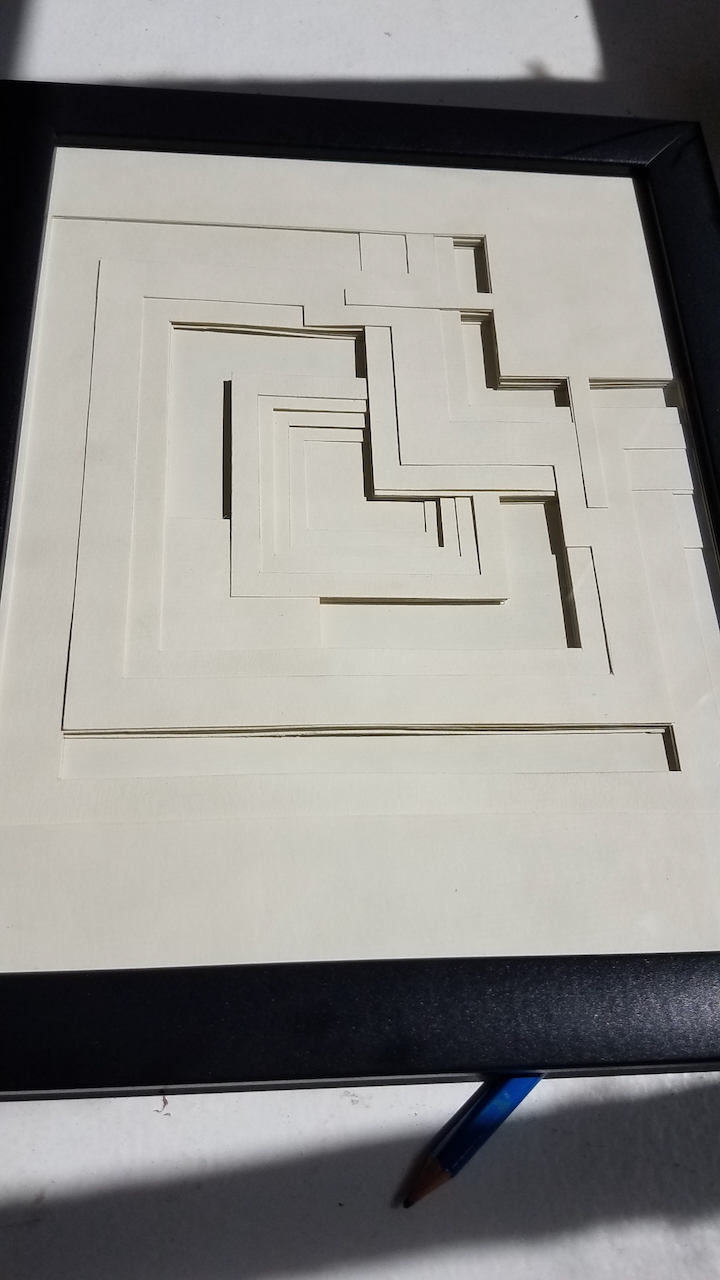 Sun lit paper layering artwork that emphasizes the depth between the layers of paper.